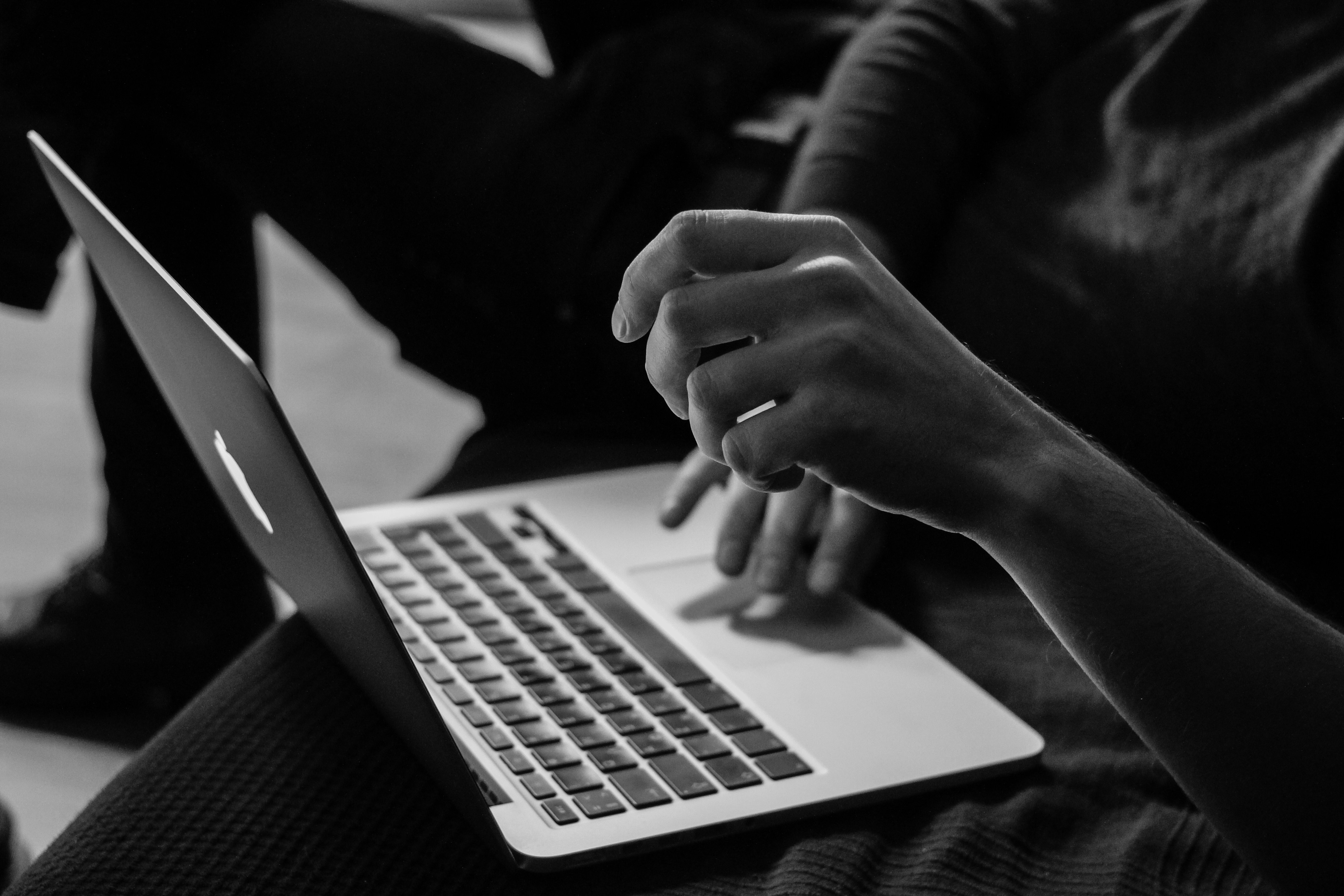 A woman on a mac computer working on a website